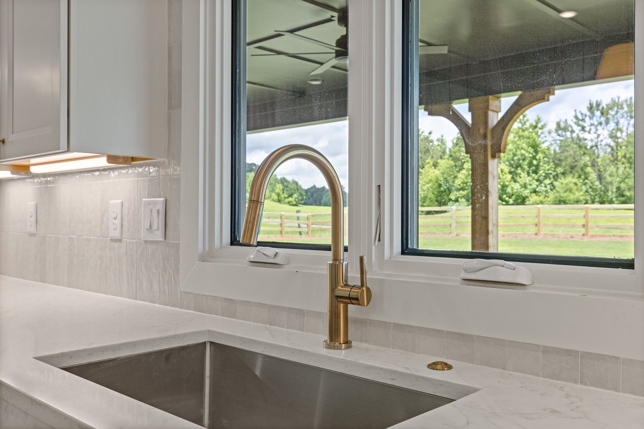 Kitchen pendant lights with pastoral window view
