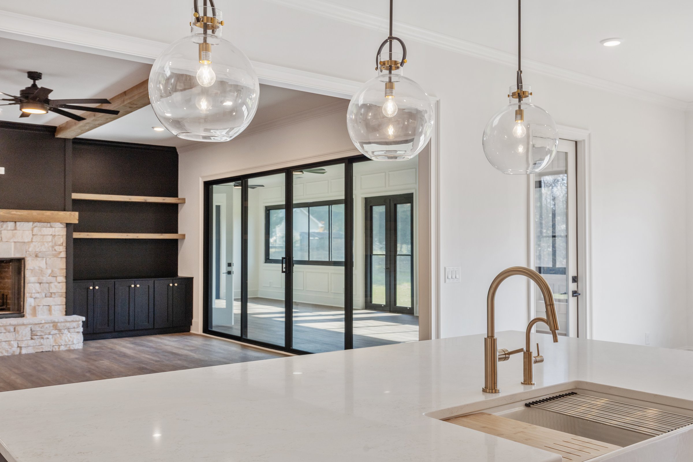 Kitchen island — globe pendants and brass sink