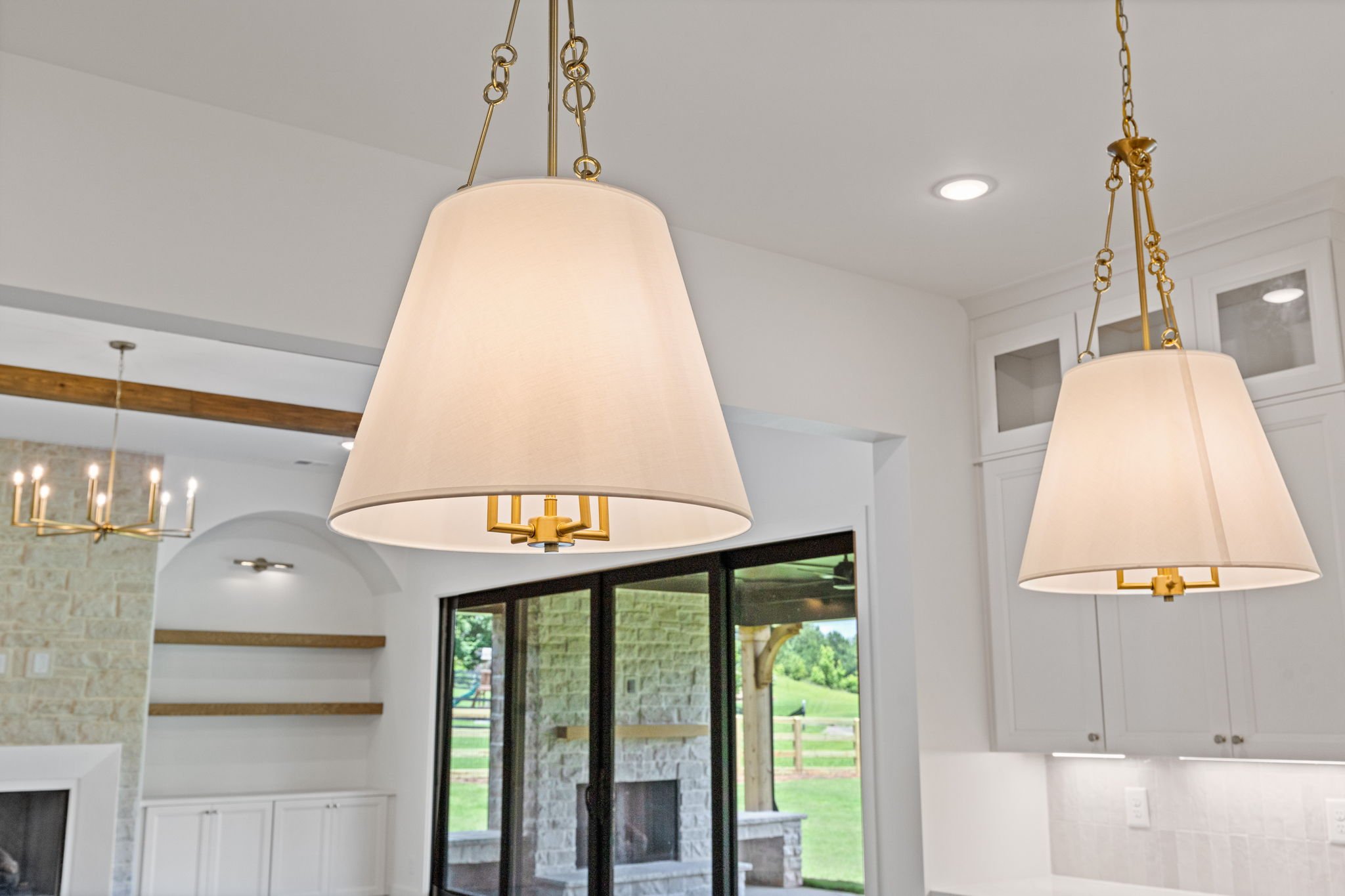 Gold pendant lights over kitchen island