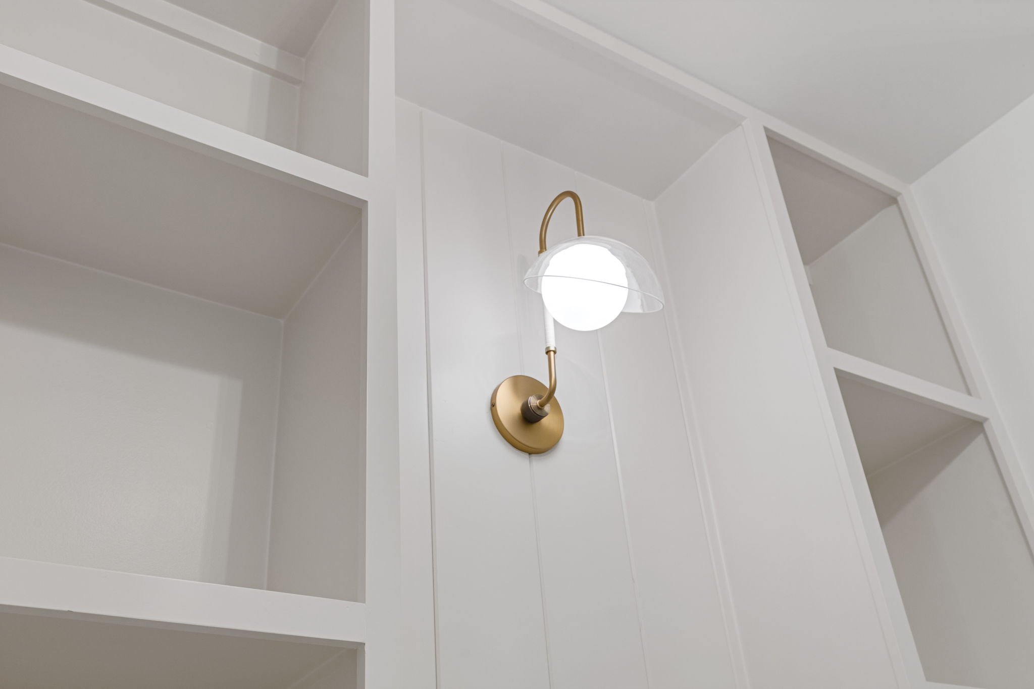 Brass sconce in custom built-in closet