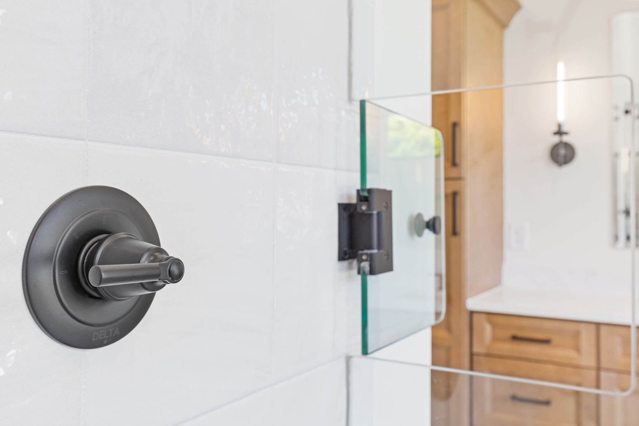 Matte black shower valve with glass door detail