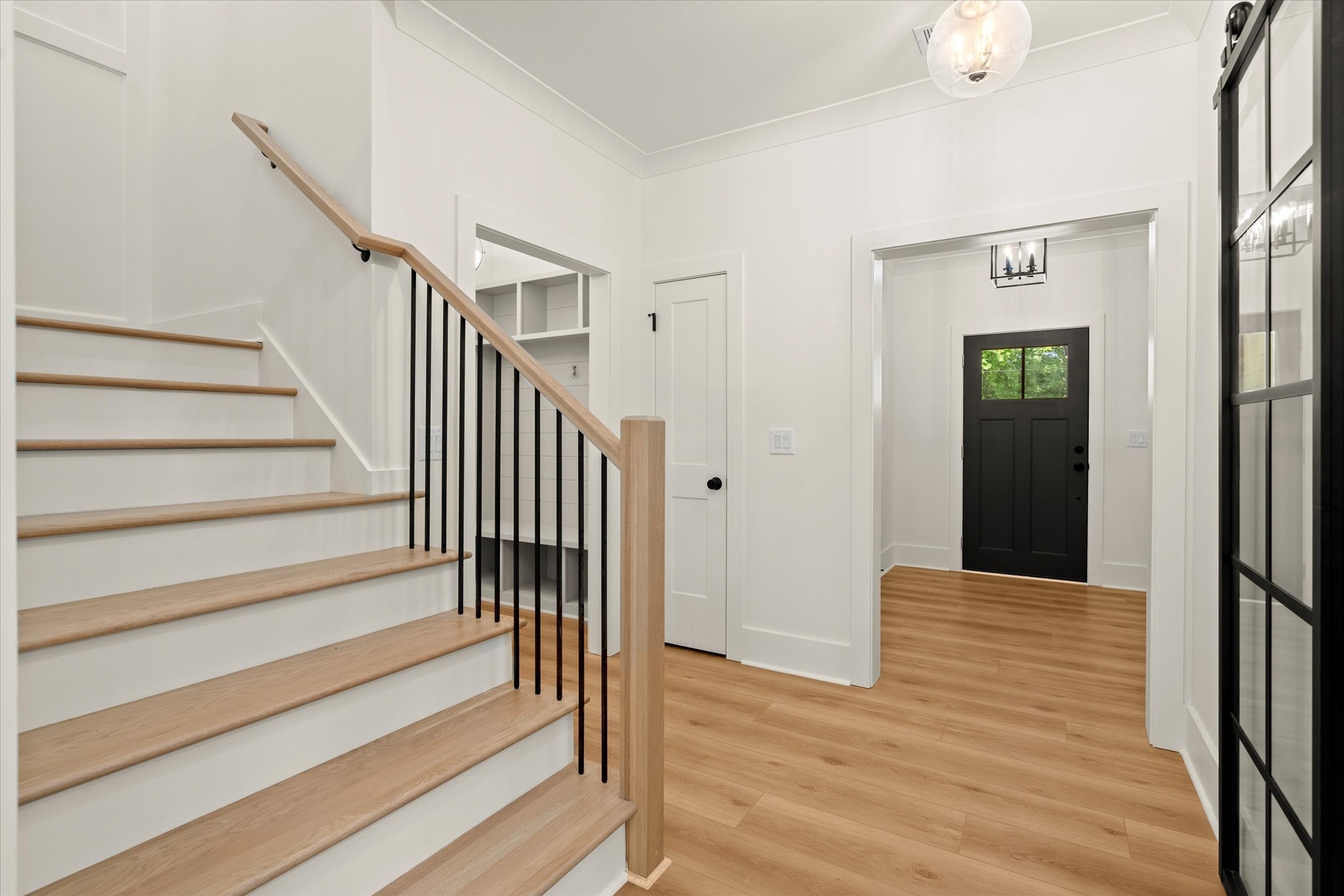 Forest and Stone — entry with staircase and black front door
