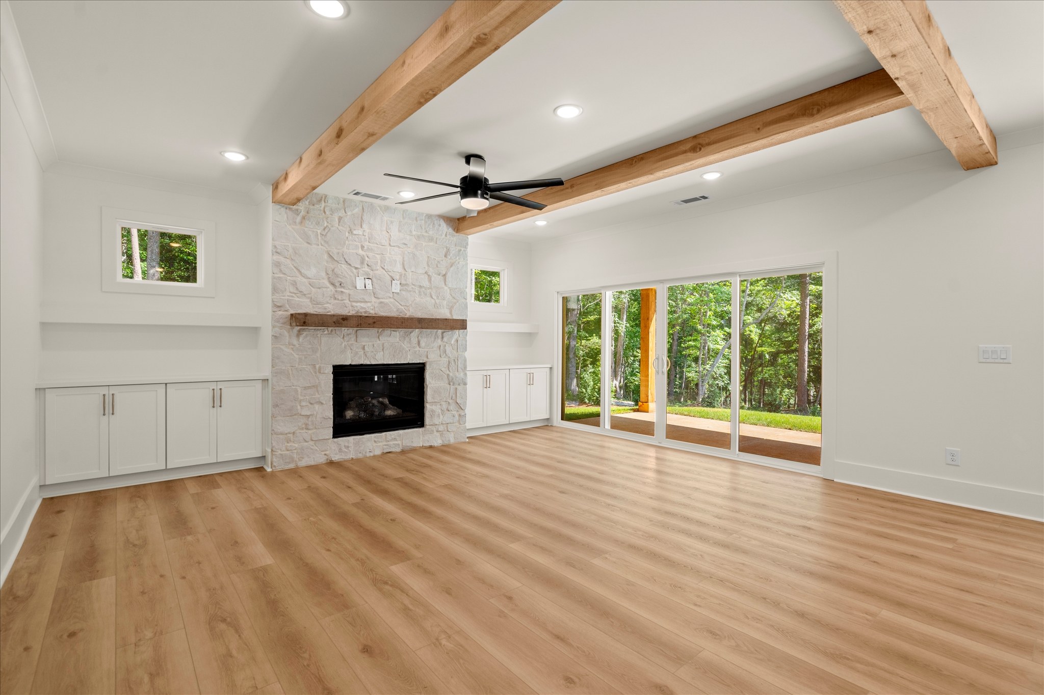 Forest and Stone — living room with stone fireplace and wood beams