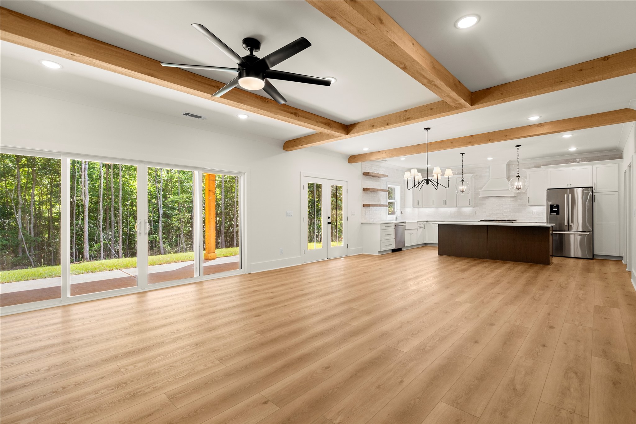 Forest and Stone — open living to kitchen with wood beams